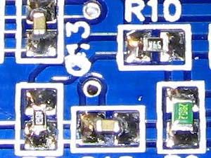 Solder all the smd capacitors.  Use a tweezer to hold the smd parts